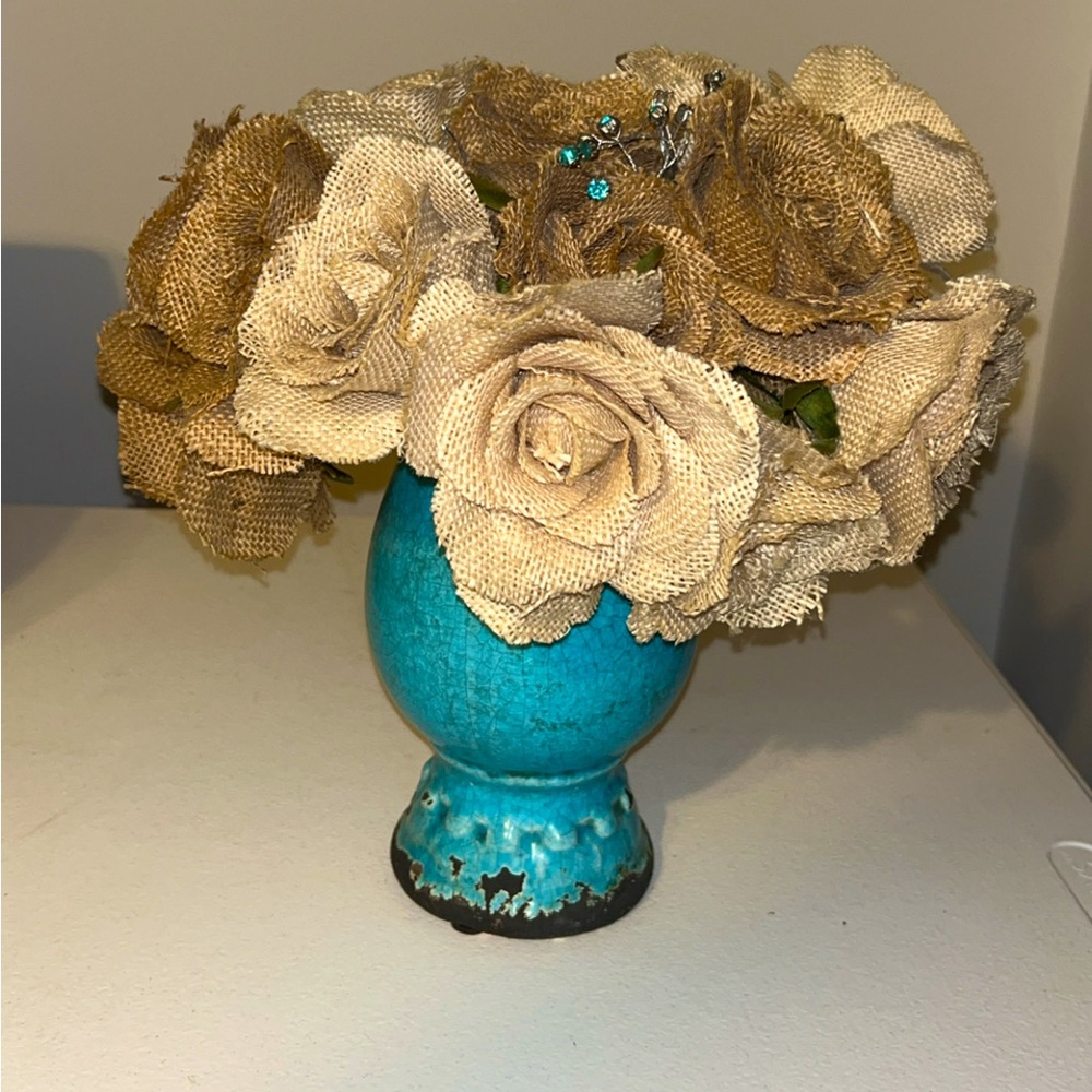 Beautiful blue ceramic vase filled with burlap flowers and diamond picks